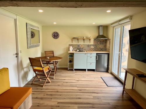 a kitchen with a table and a dining room at Quinta do espelho d'agua, Estudio in Reguengo Grande