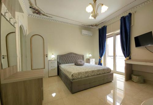 a bedroom with a bed and a large window at B&B Donna Francè Pompei - Scafati in Scafati