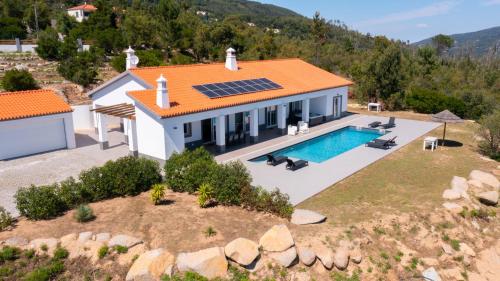 an aerial view of a house with a solar roof at Luar do Algarve in Monchique