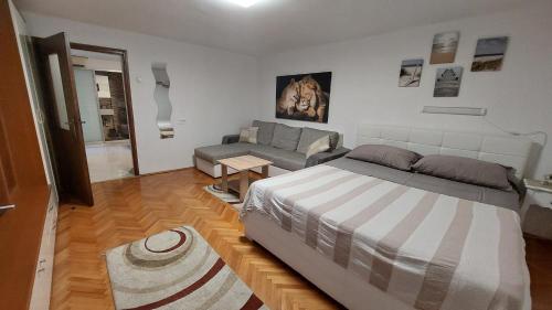 a bedroom with a bed and a couch in it at Opatija Centar in Opatija