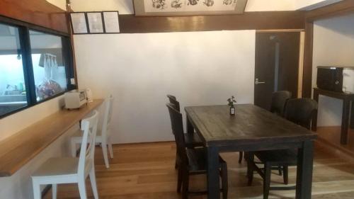 a dining room with a wooden table and chairs at Kosangan - Vacation STAY 66866v in Nagahama