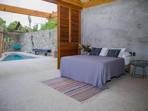 a bedroom with a bed and a swimming pool at Gotita in Yolina