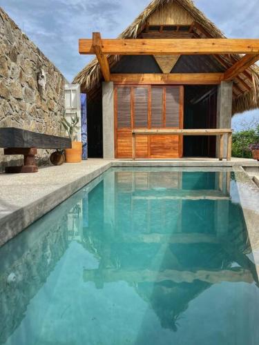 a swimming pool in front of a house at Gotita in Yolina