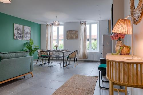 a living room with a table and chairs at La Bouverie in Romans-sur-Isère