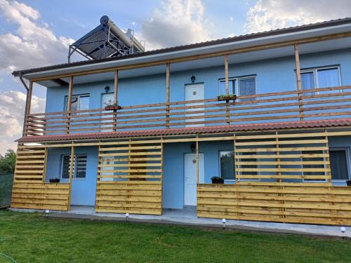 a house with wooden balconies on the side of it at Casa Sonia in Vadu