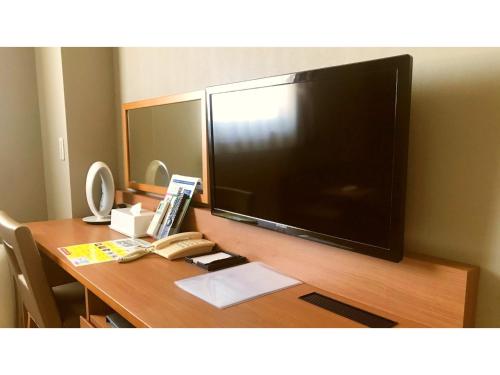 a desk with a large television on top of it at Hotel Sunrise Choshi - Vacation STAY 73442v in Choshi