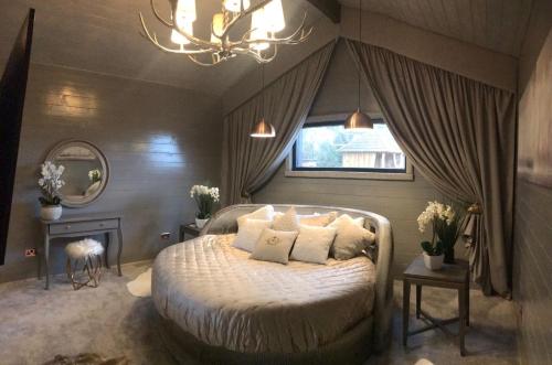 a bedroom with a bed with pillows and a window at Who'd A Thought It in Lenham