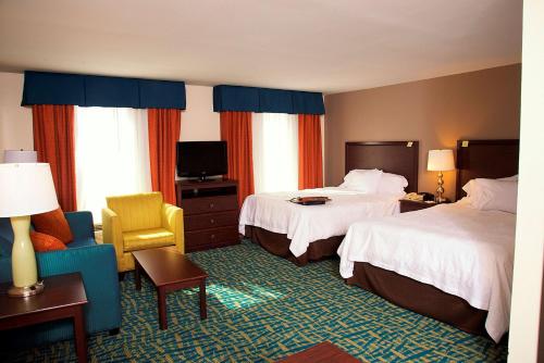 a hotel room with two beds and a chair at Hampton Inn and Suites Amarillo West in Amarillo