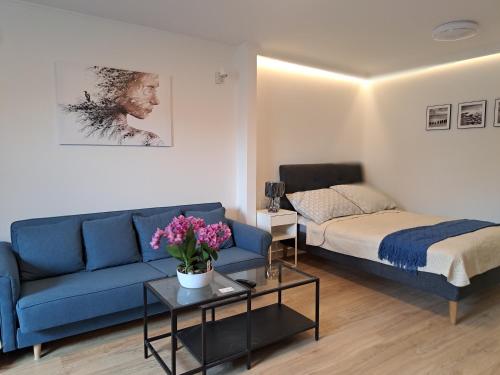 a living room with a couch and a bed at Apartament Deluxe-Gontalowy in Kazimierz Dolny