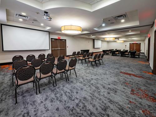 a conference room with chairs and a projection screen at Hilton Garden Inn Atlanta South-McDonough in McDonough