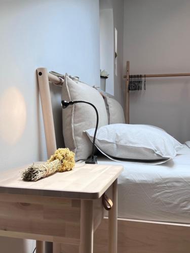 a bed and a table with a lamp on it at Apartments Forum 2 in Pula
