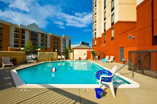 a swimming pool with a ball and a chair in a building at Hampton Inn & Suites-Atlanta Airport North-I-85 in Atlanta