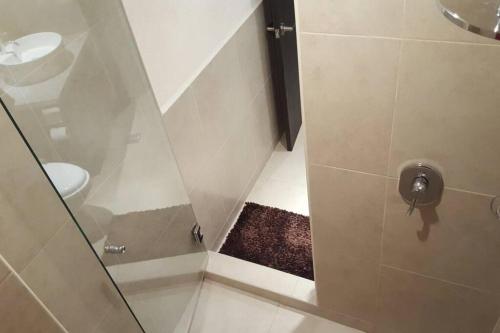 a shower with a glass door in a bathroom at Grand Venetian - Zen oceanview condo in hotel zone in Puerto Vallarta