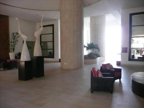 a living room with two mannequins on display in a building at Grand Venetian - Zen oceanview condo in hotel zone in Puerto Vallarta