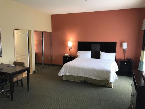 a hotel room with a large bed and a desk at Hampton Inn and Suites Austin - Lakeway in Lakeway