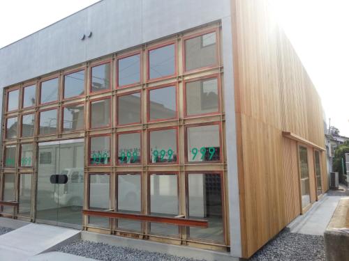 a building with glass windows on the side of it at Yado Seven Beach in Naoshima