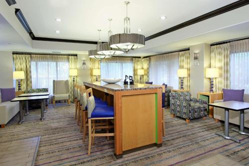 a living room with a kitchen and a dining room at Hampton by Hilton Austin South - I-35 & Ben White in Austin