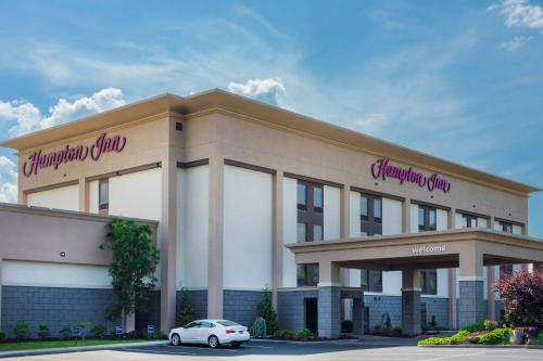 a building with a car parked in front of it at Hampton Inn Bedford in Bedford