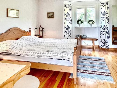 a bedroom with a large bed with a wooden frame at 7 person holiday home in KöPINGSVIK-By Traum in Köpingsvik