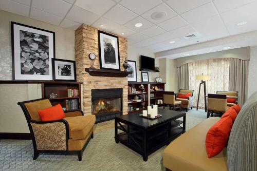 a living room with a couch and a fireplace at Hampton Inn Jasper, AL in Jasper