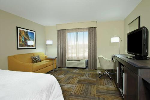 a hotel room with a bed and a desk with a tv at Hampton Inn Jasper, AL in Jasper