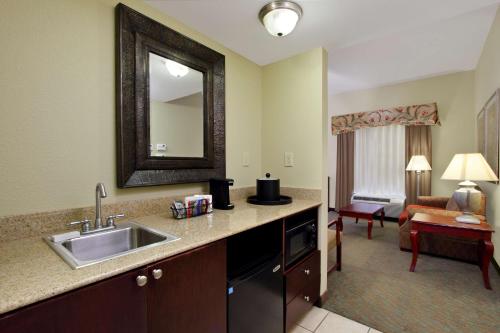 a kitchen with a sink and a living room at Hampton Inn Jasper in Jasper