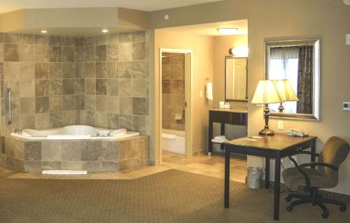a bathroom with a tub and a desk and a desk at Hampton Inn & Suites Billings West I-90 in Billings