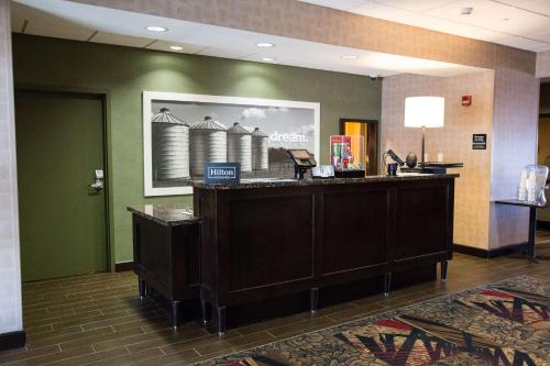 a lobby with a reception desk in a hospital at Hampton Inn & Suites Bismarck Northwest in Bismarck