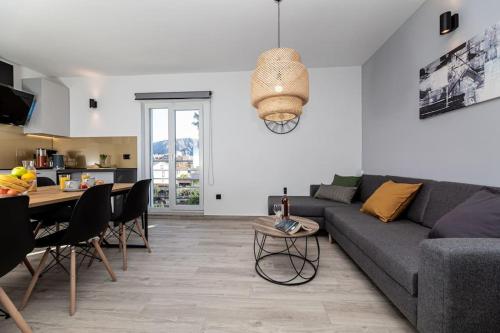 a living room with a couch and a table at Apartman Milazzi in Baška