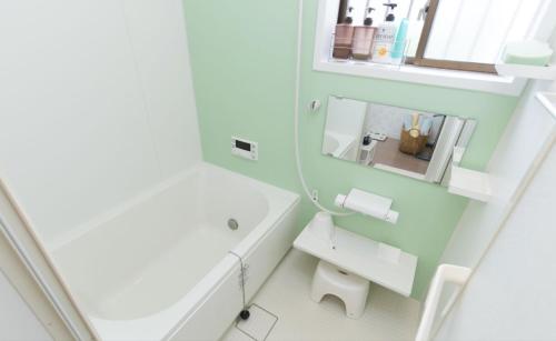 a bathroom with a white sink and a mirror at Chikuan Kyoto Whole Rental Lodging - Vacation STAY 78789v in Nishi-kujō-Toriiguchichō