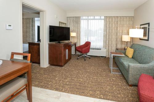 a living room with a couch and a television at Hampton Inn & Suites Nashville-Green Hills in Nashville