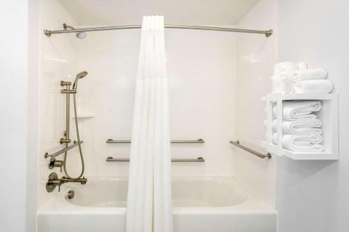 a white bathroom with a shower and a bath tub at Hampton Inn & Suites Nashville-Green Hills in Nashville