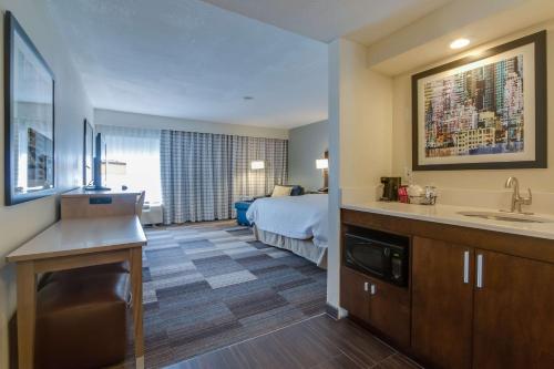 a hotel room with a bed and a bathroom at Hampton Inn Bellevue/Nashville I-40 West in Bellevue