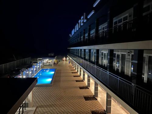 a large building with a swimming pool at night at VIP HOTEL ZATOKA in Zatoka