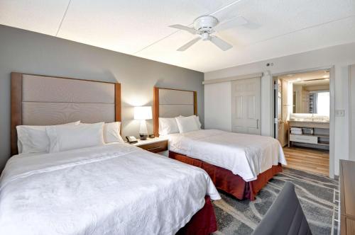 a hotel room with two beds and a ceiling fan at Homewood Suites Boston Peabody in Peabody