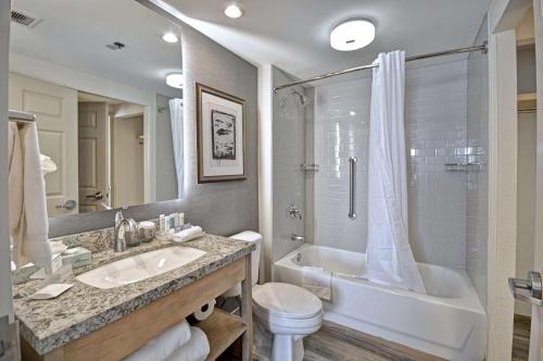 a bathroom with a sink and a tub and a toilet at Homewood Suites Boston Peabody in Peabody