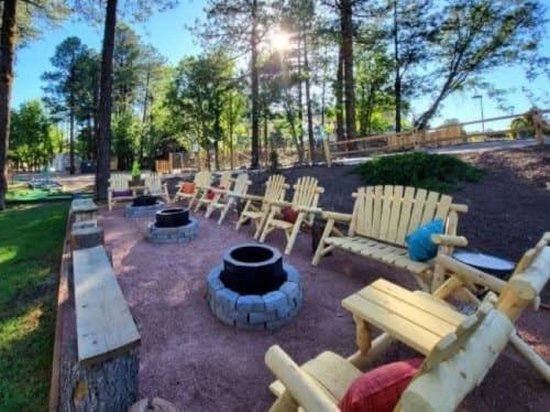 a group of wooden benches sitting in a park at The Nook Pinetop in Pinetop-Lakeside