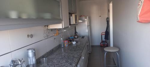a kitchen with a sink and a counter top at Confortable Apartamento en Microcentro in Barraquero