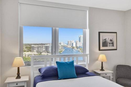 a bedroom with a bed and a large window at Perfect Vacation 4 Bedroom Condo Beach Access in Hallandale Beach