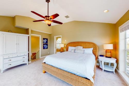 a bedroom with a bed and a ceiling fan at Dixie Beach Delight in Sanibel