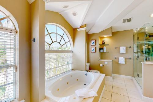 a bathroom with a large tub and a window at Dixie Beach Delight in Sanibel