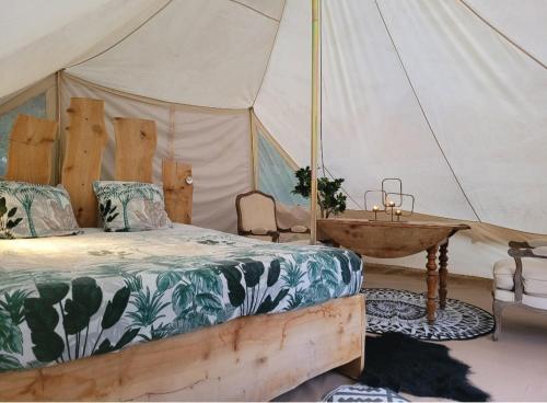 a bedroom with a bed and a sink in a tent at Loz'aire naturelle in Quézac