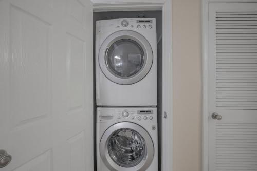 two washing machines and a washer and dryer in a room at Navy Cove Harbor 1205 by Vacation Homes Collection in Fort Morgan