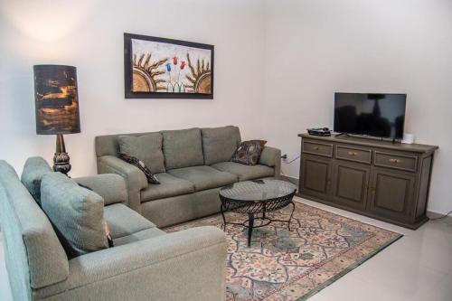 a living room with a couch and a tv at Casa Lana Central in Ajijic