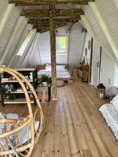 a bedroom with a bed and a wooden floor at Căsuța cu doi brazi in Baia Mare