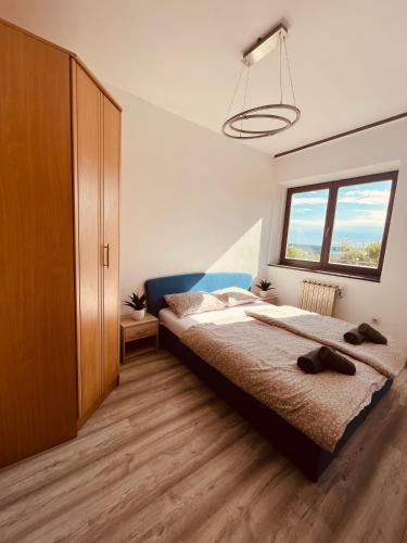 a bedroom with a bed and a large window at Lea apartment in Lucija