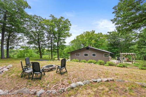 a yard with four chairs and a playground at Glen Lake Ridge in Empire
