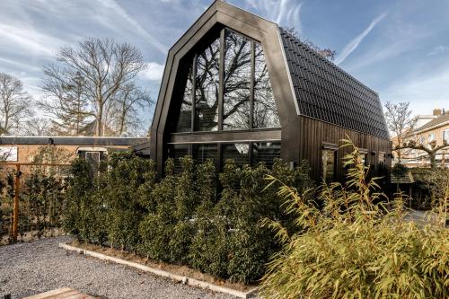 a building with a lot of plants in front of it at Lovely private cottage near Amsterdam in Broek in Waterland