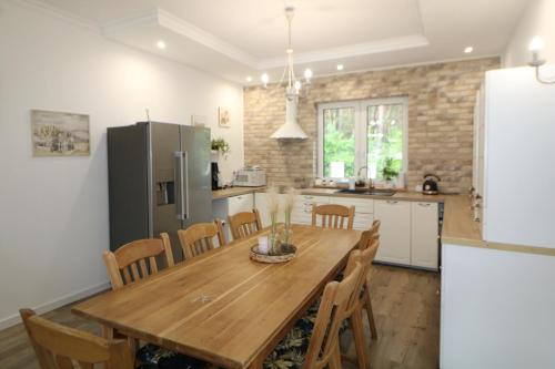 cocina y comedor con mesa de madera y sillas en RETRO WILLA, en Koronowo