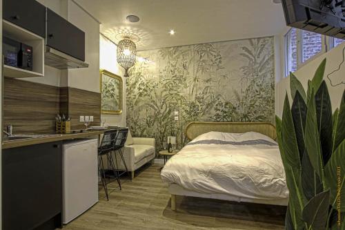 a bedroom with a bed and a kitchen with a sink at CosyRouen Bali Spa Hamman in Rouen